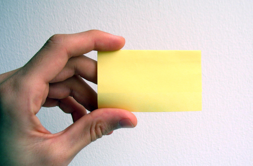 Empty business card, hand, yellow free powerpoint background